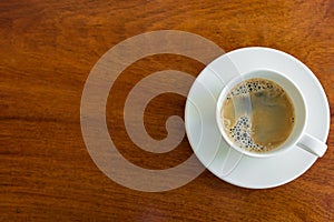 Espresso cup on a wood table.