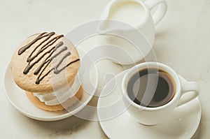 Espresso with dessert and milk on white background/Espresso with dessert and milk on white marble background, top view