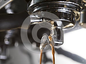 Espresso extraction with a proffessional coffee machine photo