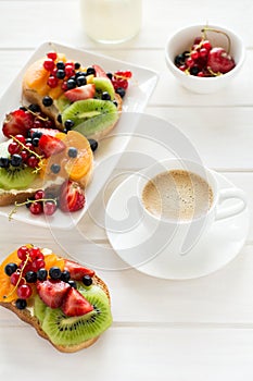 Espresso and fruit dessert sandwiches with ricotta cheese, kiwi, apricot, strawberry, blueberry and red currant