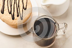 Espresso glass with milk and dessert on white marble background/Espresso glass with milk and dessert on white marble background.