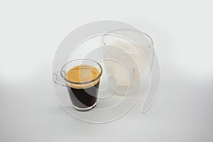 Espresso in a glass shot with fresh coconut juice in double walls glass isolated on white