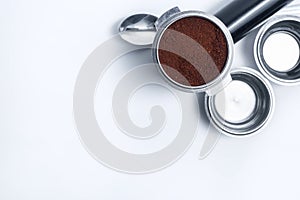 Espresso holder and replaceable coffee filters. The horn from the coffee machine on a white background. Selective focus