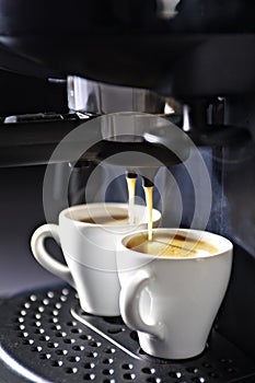Espresso machine with cups of coffee