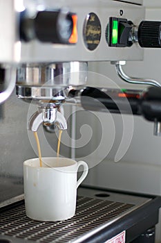 Espresso Machine Dripping Espresso into White Cup