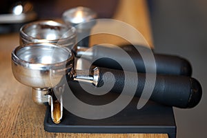 Espresso machine holders on rubber pad at table, closeup