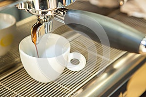Espresso machine pouring coffee in cup