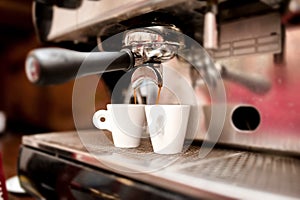 Espresso machine pouring coffee in cups
