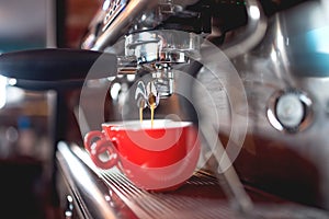 espresso machine pouring coffee in cups at restaurant or pub. Barista concept with machinery, tamper, coffee and tools