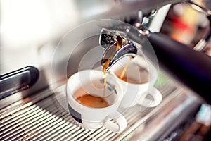 Espresso machine pouring fresh coffee into cups at restaurant. Coffee automatic machine making coffee