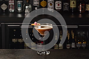 Espresso Martini Cocktail based on coffee, liqueur and vodka. Served with orange chips and raspberry. Space for text