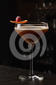 Espresso Martini Cocktail based on coffee, liqueur and vodka. Served with orange chips and raspberry. Space for text