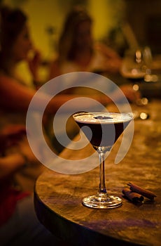 Espresso martini cocktail drink in cozy dark bar interior