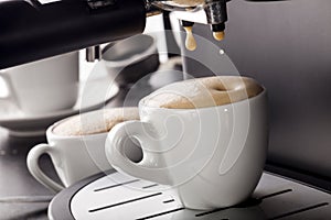 Espresso pouring from coffee machine.