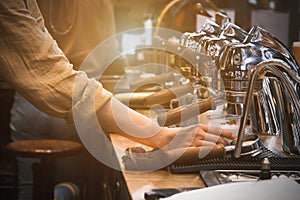 Espresso pouring from coffee machine. coffee machine preparing fresh coffee and pouring into red cups at restaurant