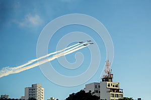 Esquadrao da Fumaca performing on Bahia independence day above the buildings photo