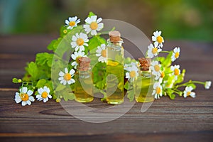 Essence of flowers on table in beautiful glass bottle