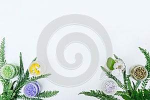 Essence of wild flowers - glass bottles with yellow and white liquids and wild flowers on white background - spa, wellness or
