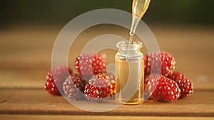 Essence of Wild raspberries  on table in beautiful glass Bottle