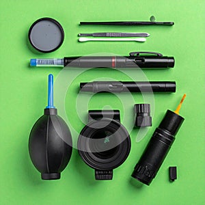 Essential Camera Cleaning Tools on Green Background