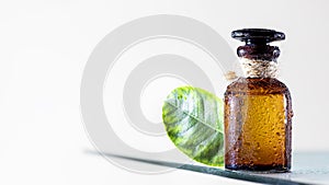 Essential oil for aromatherapy, alternative medicine. Closeup brown glass bottle. Skin care, natural medicine