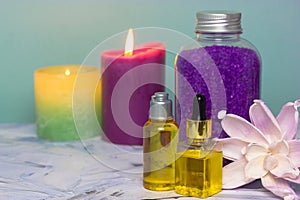 Essential oil for body care, lavender sea salt in bottle burning candles in bath