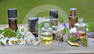 essential oil bottles with flowers on a table