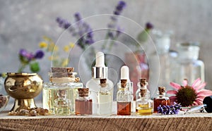 Essential oil bottles with frankincense, echinacea and lavender flowers