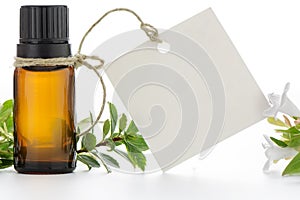 Essential oil, empty tags and flowers