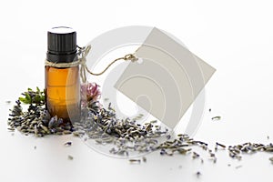 Essential oil, empty tags and lavender flowers