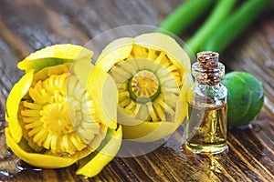 Essential oil in glass bottle with fresh flowers of Nuphar lutea, Yellow Water-lily, Brandy-Bottle-beauty treatment. Spa concept.