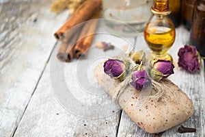 Essential oil and handmade soap on wooden background