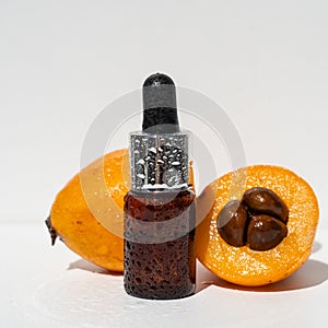 Essential oil of Japanese medlar. Nepole frutta Japanese medlar. photo