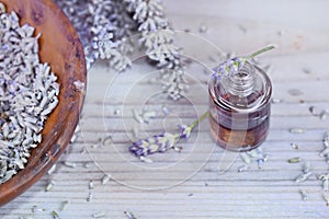 Essential oil from lavender  in bottle and dried flowers