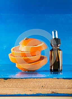 Essential oil with orange slices, bottle and dropper