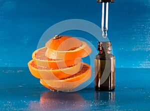 Essential oil with orange slices, bottle and dropper