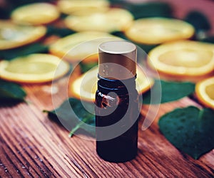 Essential oil from oranges on wooden background - alte