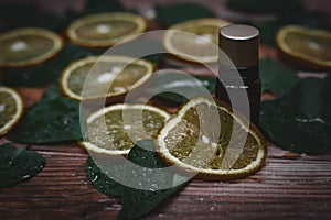 Essential oil from oranges on wooden background - alte