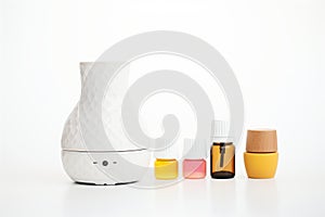 essential oils and ceramic diffuser on white background