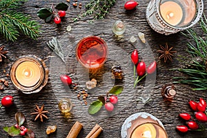 Christmas background with bottles of essential oil, myrrh, frankincense, candles, wintergreen and Christmas spices