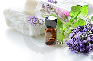 Essential oils and cosmetics with lavender and herbs photo