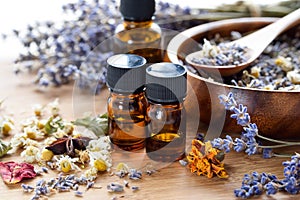 Essential oils with dried herbs photo