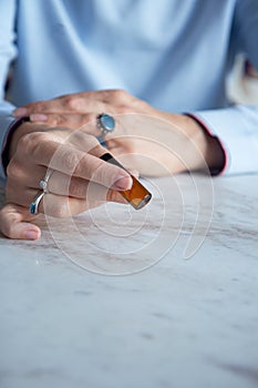 Essential oils glass bottle in the hand of a woman