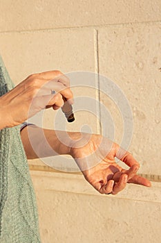 Essential oils roller bottle in the hand of a woman