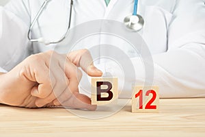 Essential vitamins and minerals for humans. B12 alphabet on wood cube. doctor recommends taking vitamin b12. doctor talks about