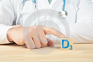 Essential vitamins and minerals for humans. vitamin D3 alphabet on wood cube. doctor recommends taking vitamin D. doctor talks