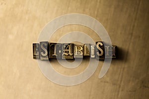 ESTABLISH - close-up of grungy vintage typeset word on metal backdrop