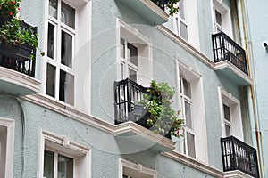 establish shot of a hotel building with balcony against blue sky