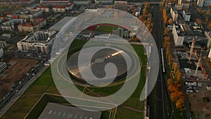 Establishing Aerial Shot above Futuristic Velodrome Building cycling Arena in Berlin, Germany, Aerial tilt up view at