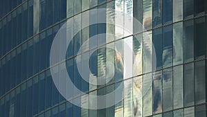 Establishing shot of modern glass building wall, windows of company offices